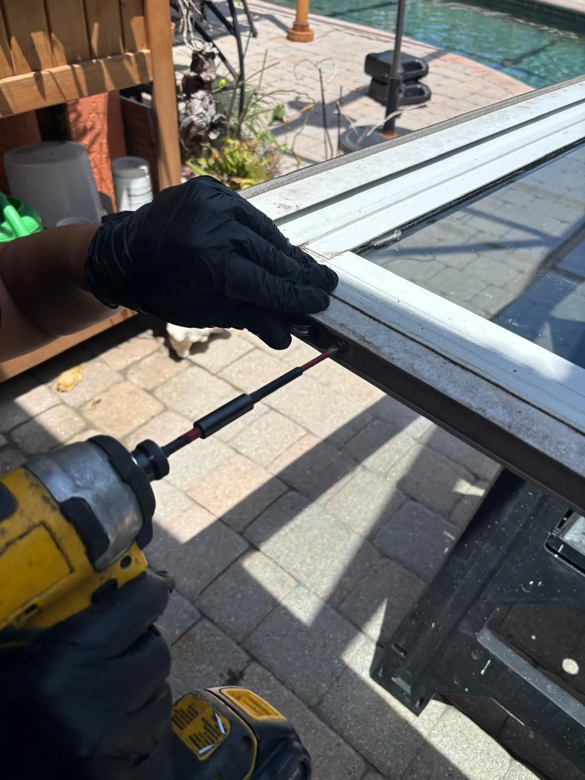 Removing old sliding glass door rollers during a repair service