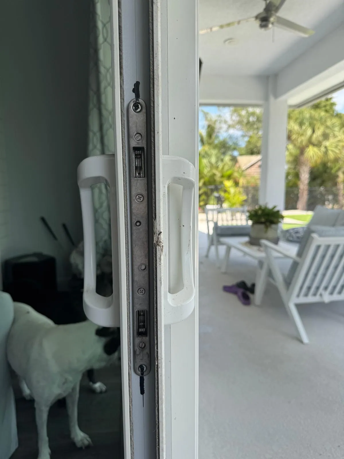Sliding door lock and handle hardware showing wear on a Florida patio door