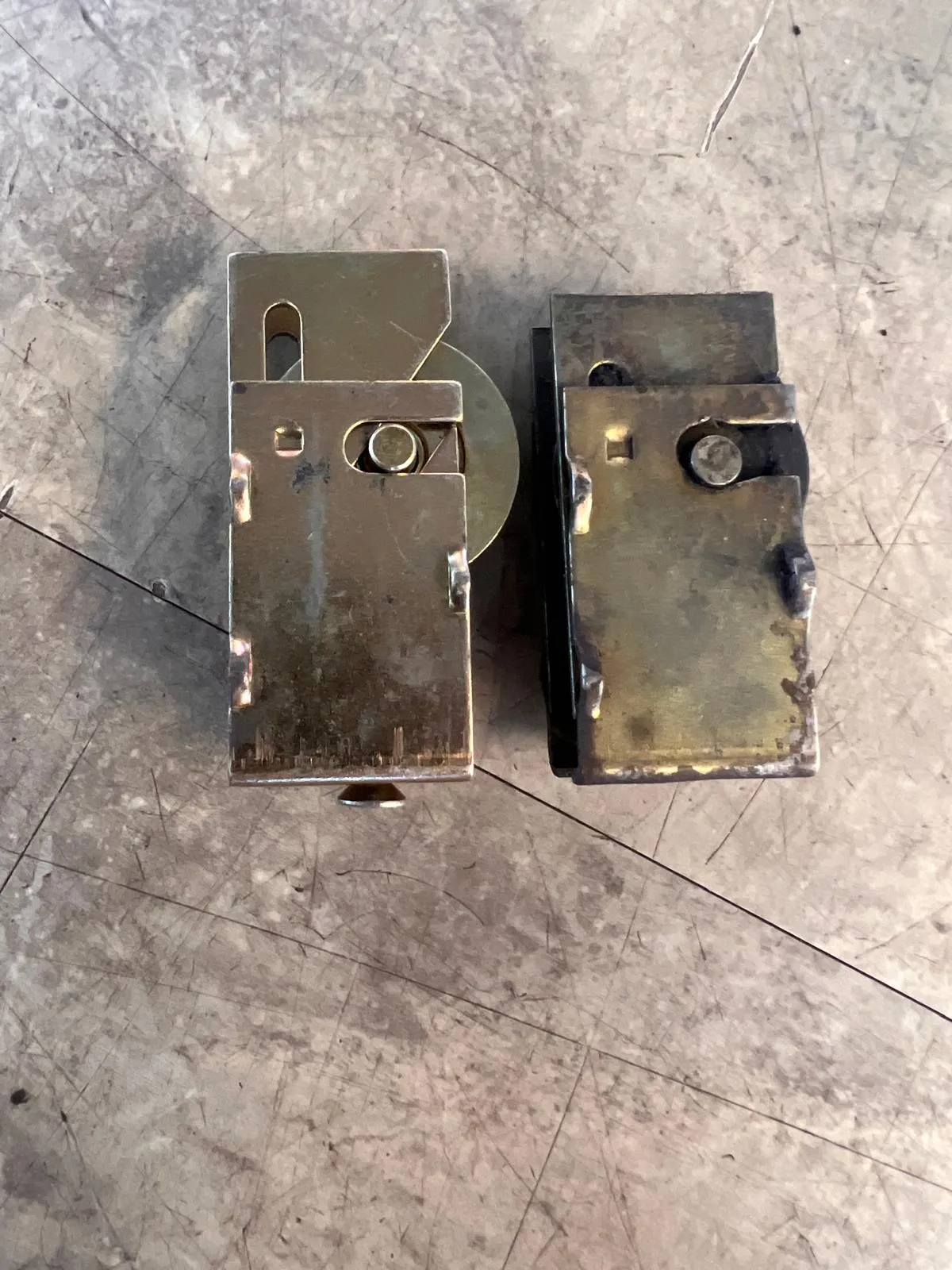 Close-up of sliding door roller assemblies showing old vs new comparison