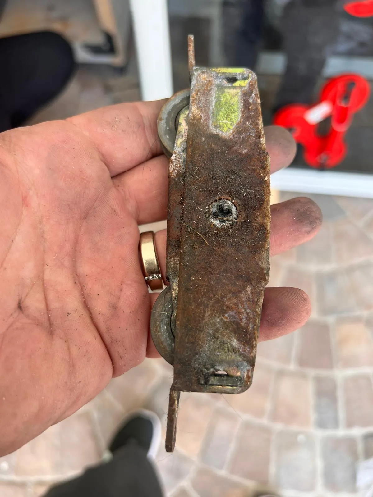 Heavily rusted sliding door rollers from a coastal Broward County home