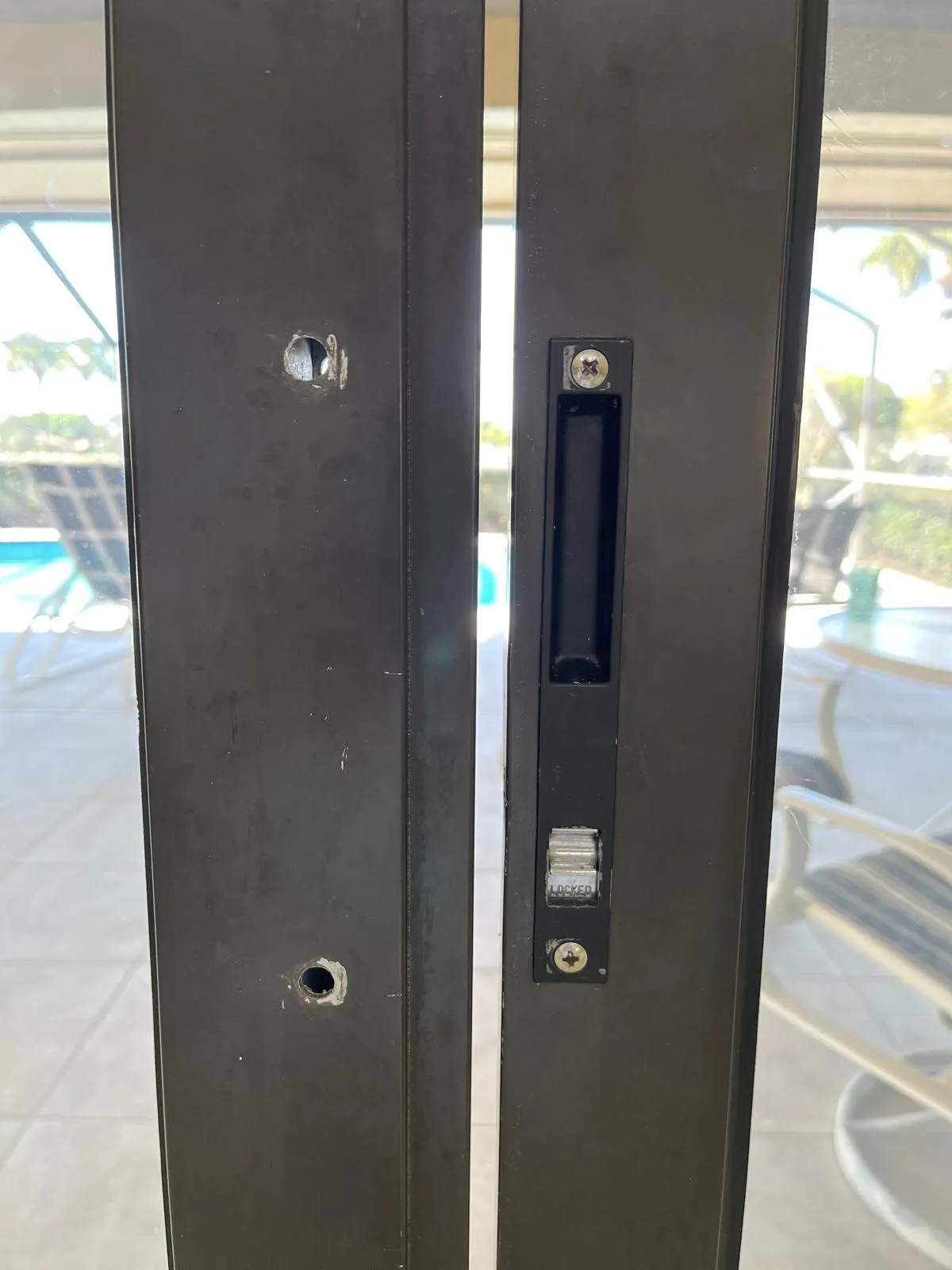 Broken sliding door lock on a Florida patio door needing replacement