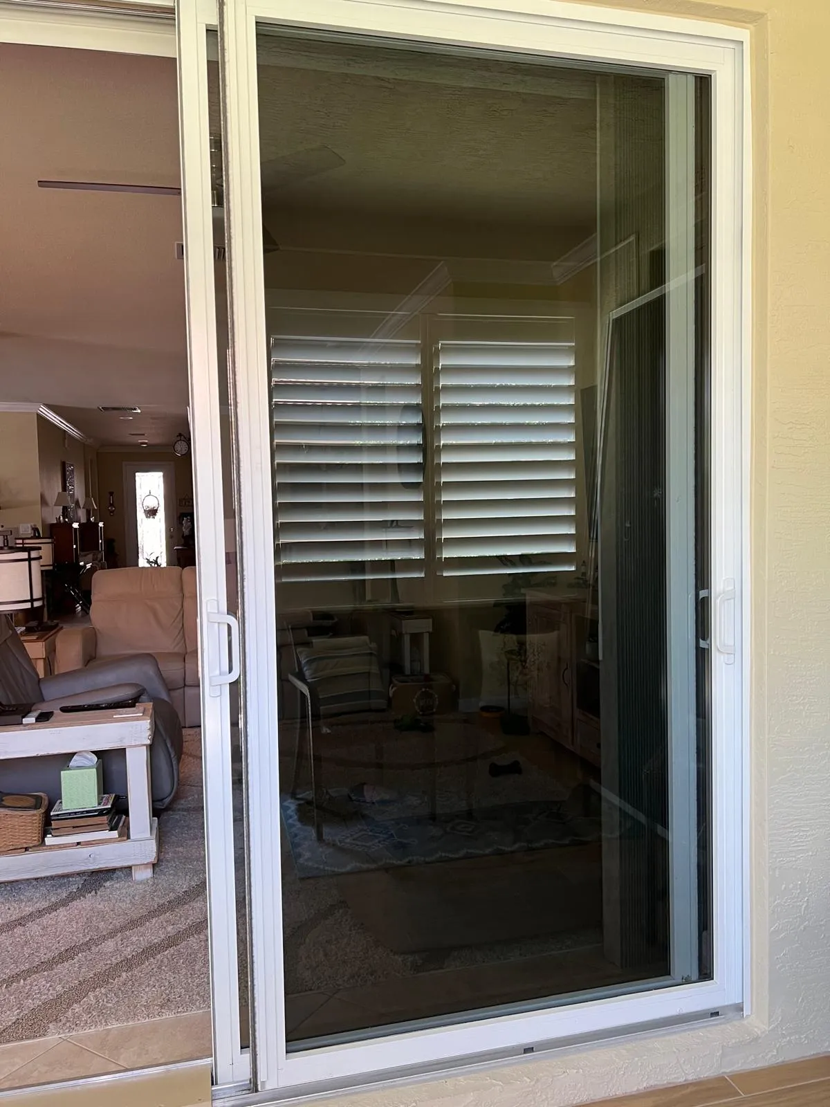 Expert technician installing new security lock on sliding glass door
