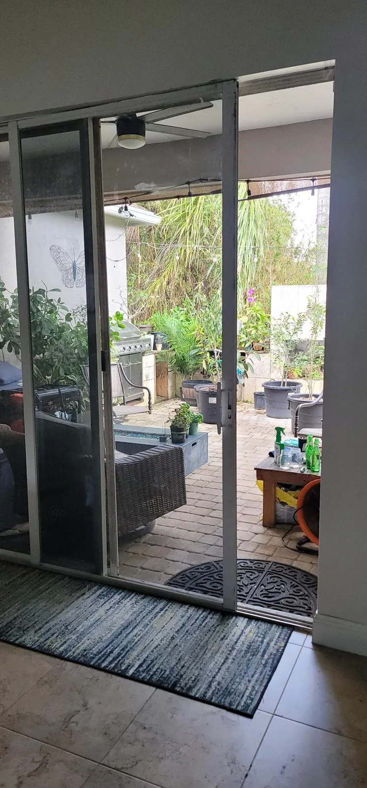 Professional technician repairing broken sliding door lock at a Broward County residential property